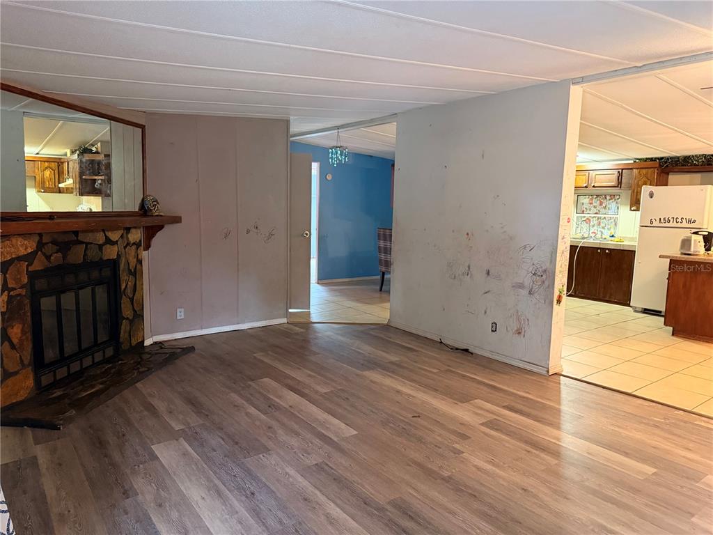 24021 Armadillo Road Astor, FL 32102 - Photo 9 of 38 a view of a livingroom with wooden floor and a flat screen tv