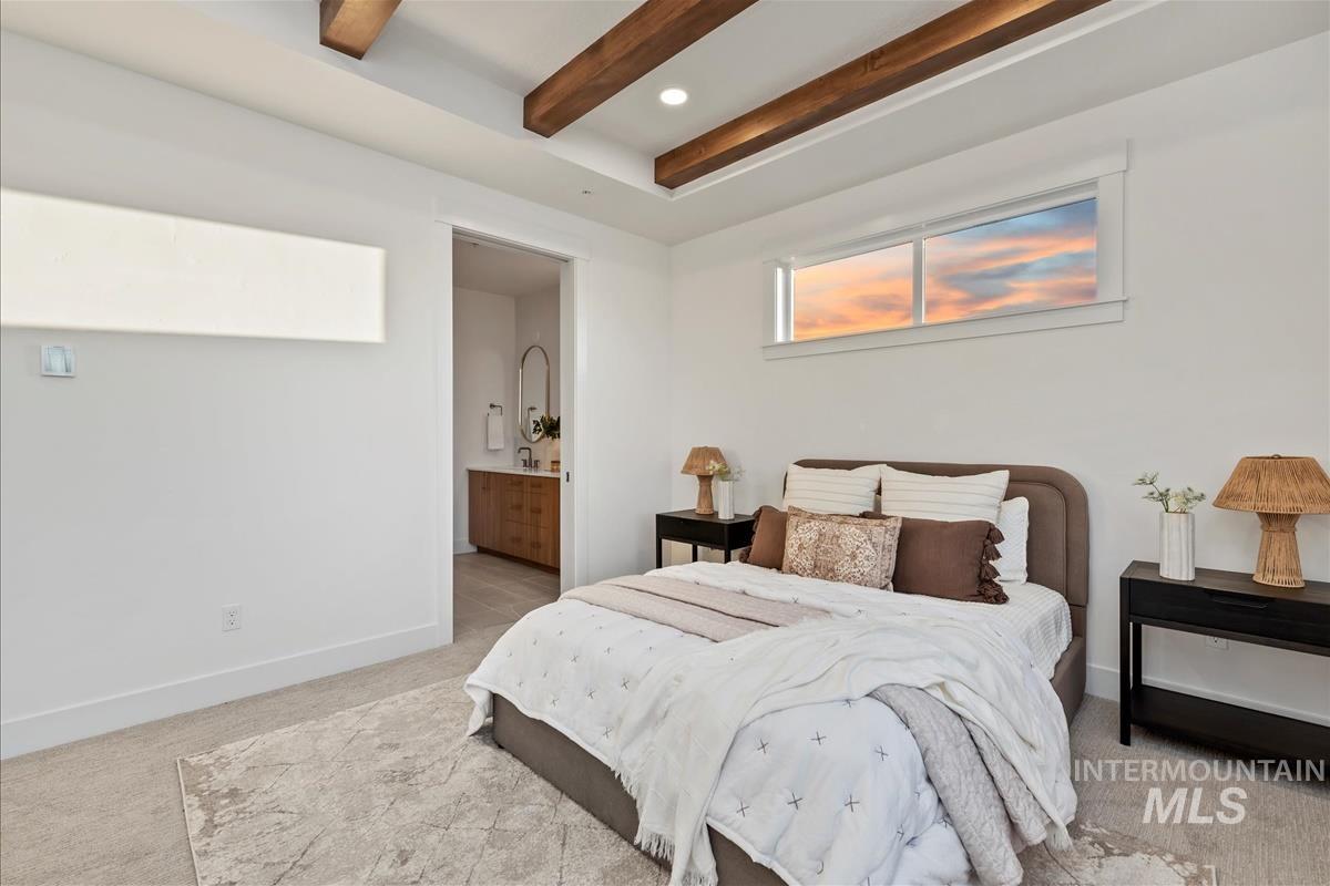 3243 West Moore Street Boise, ID 83702 - Photo 16 of 38 Bedroom with light carpet, beamed ceiling, and ensuite bath