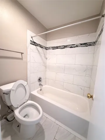 a bathroom with a tub a sink and a mirror