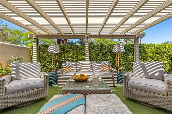 a outdoor living space with furniture and a rug