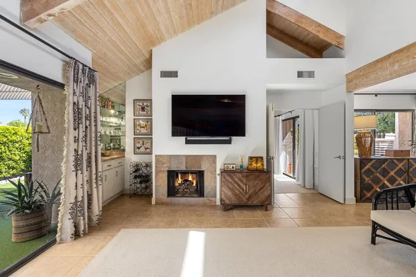 a very nice looking living room with a large window and wooden floor