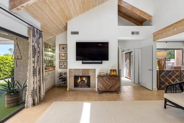 a very nice looking living room with a large window and wooden floor