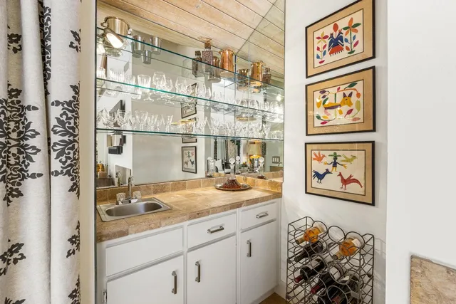 a kitchen with kitchen island granite countertop a stove sink and cabinets