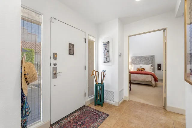 a spacious bedroom with a bed and glass door