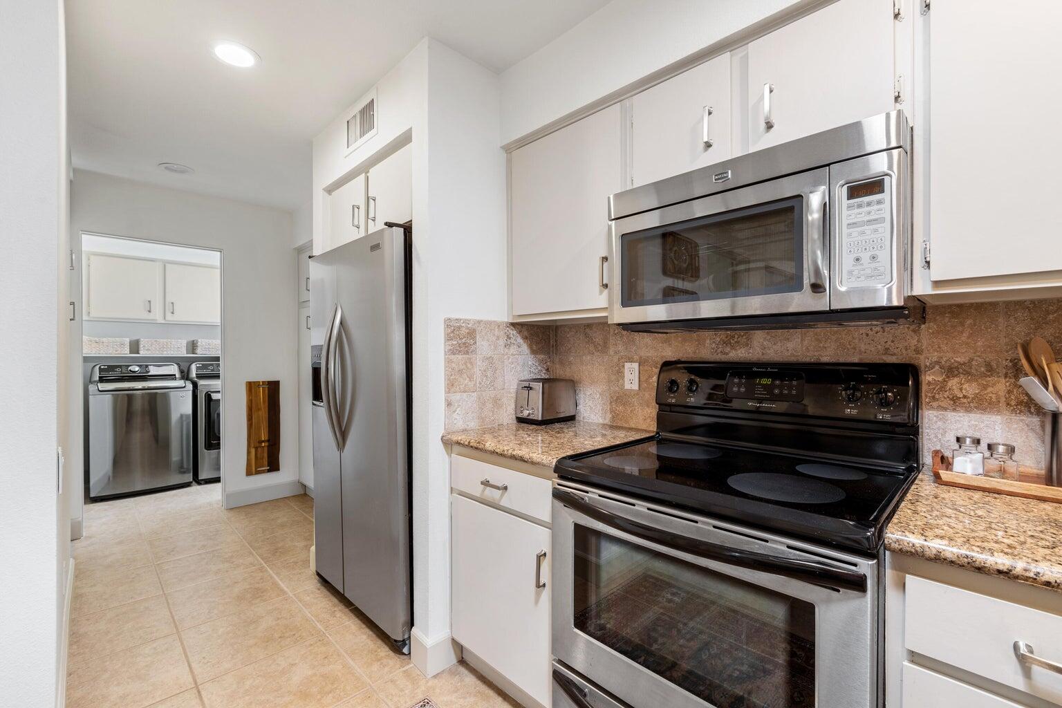 303 Forest Hills Drive Rancho Mirage, CA 92270 - Photo 25 of 71 a kitchen with cabinets and stainless steel appliances