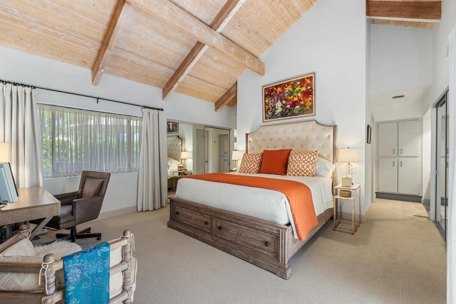 303 Forest Hills Drive Rancho Mirage, CA 92270 - Photo 28 of 71 a spacious bedroom with a bed and glass door