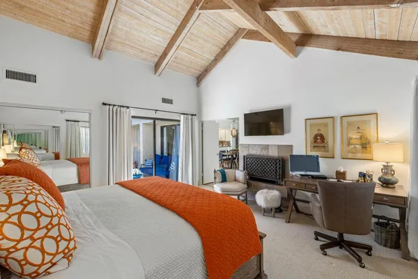 a bedroom with two beds and a flat screen tv