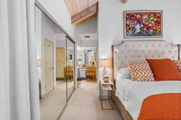 a bedroom with furniture and a flat screen tv