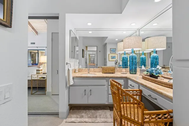 a bedroom with two beds and lamp