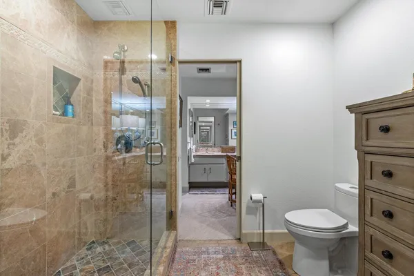 a bathroom with a sink a toilet and shower
