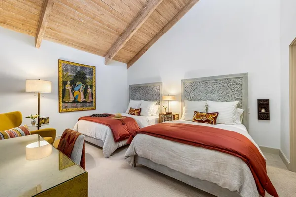 an aerial view of residential houses with outdoor space and mountains