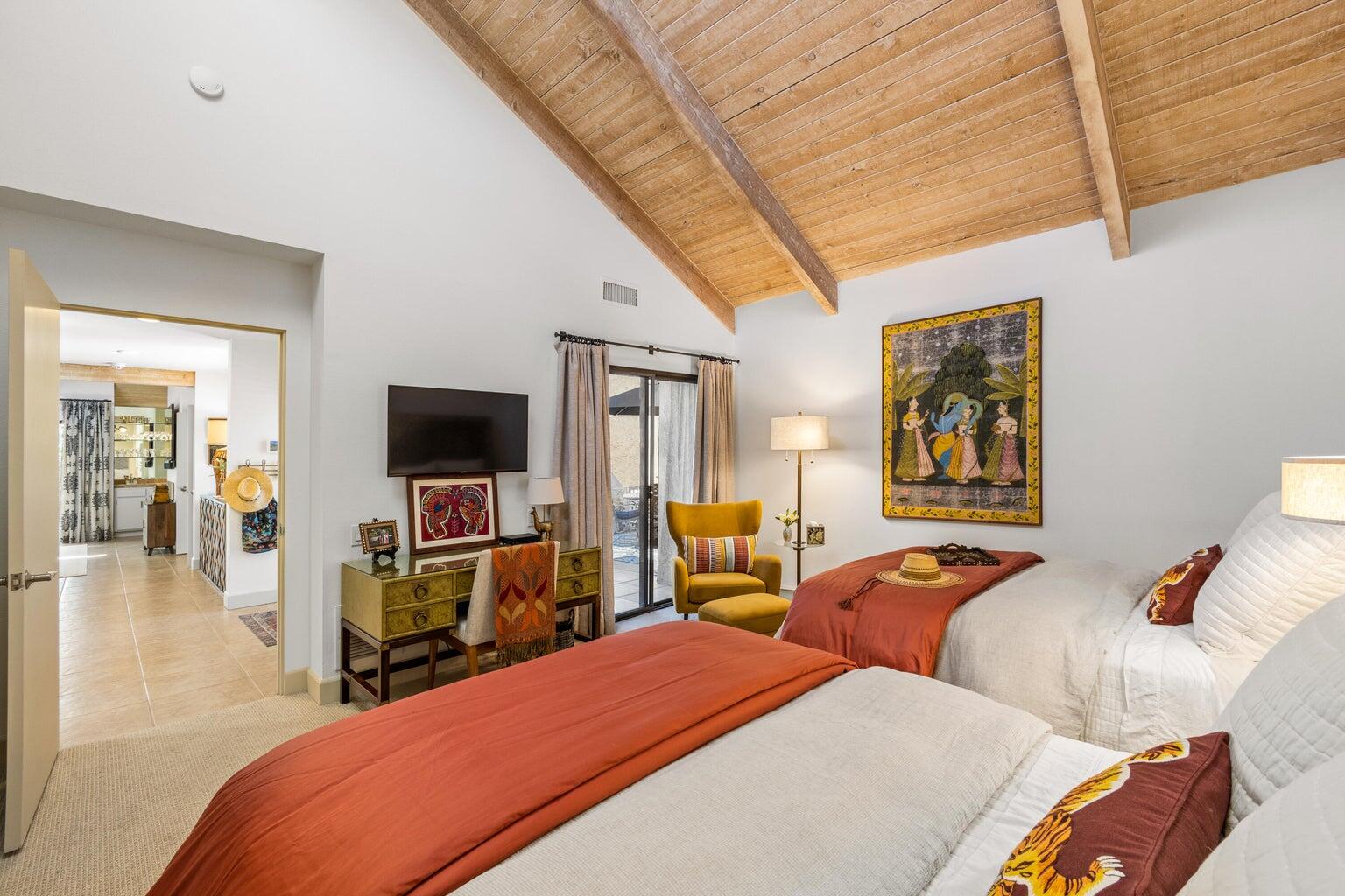 303 Forest Hills Drive Rancho Mirage, CA 92270 - Photo 39 of 71 a bedroom with two beds and a flat screen tv