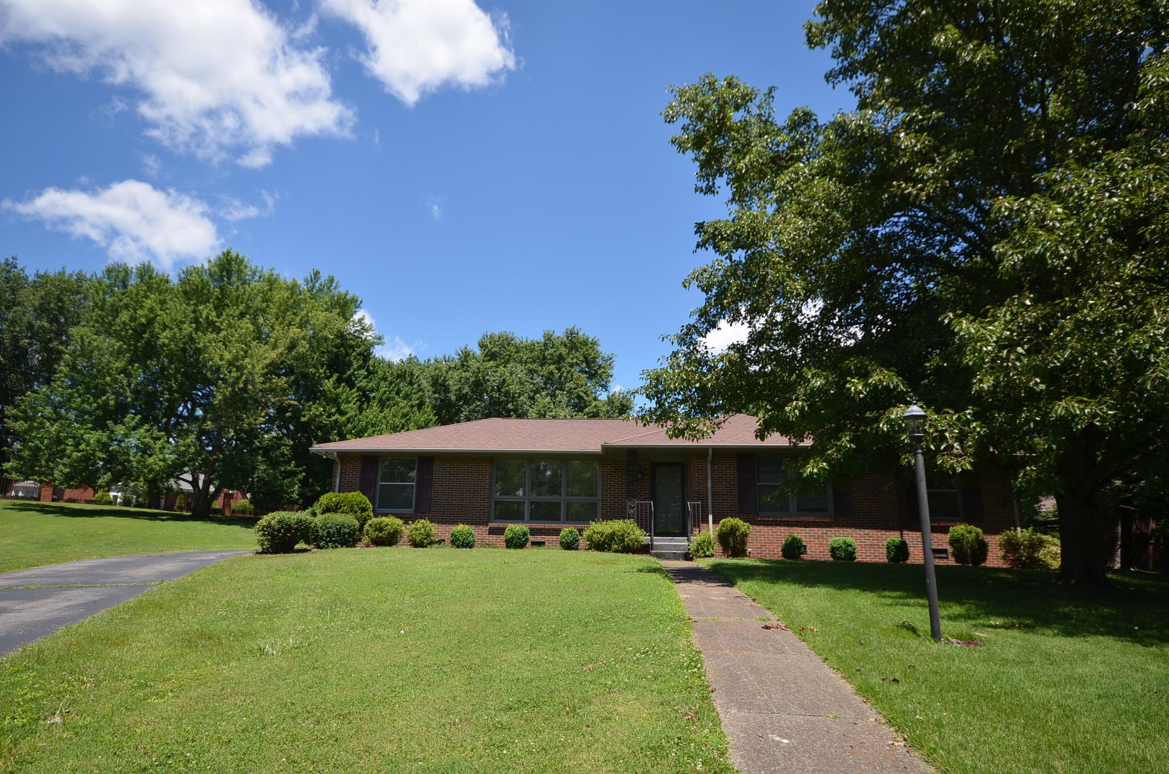 310 Kimbrough Road Clarksville, TN 37043 - Photo 1 of 25 a front view of a house with garden and trees