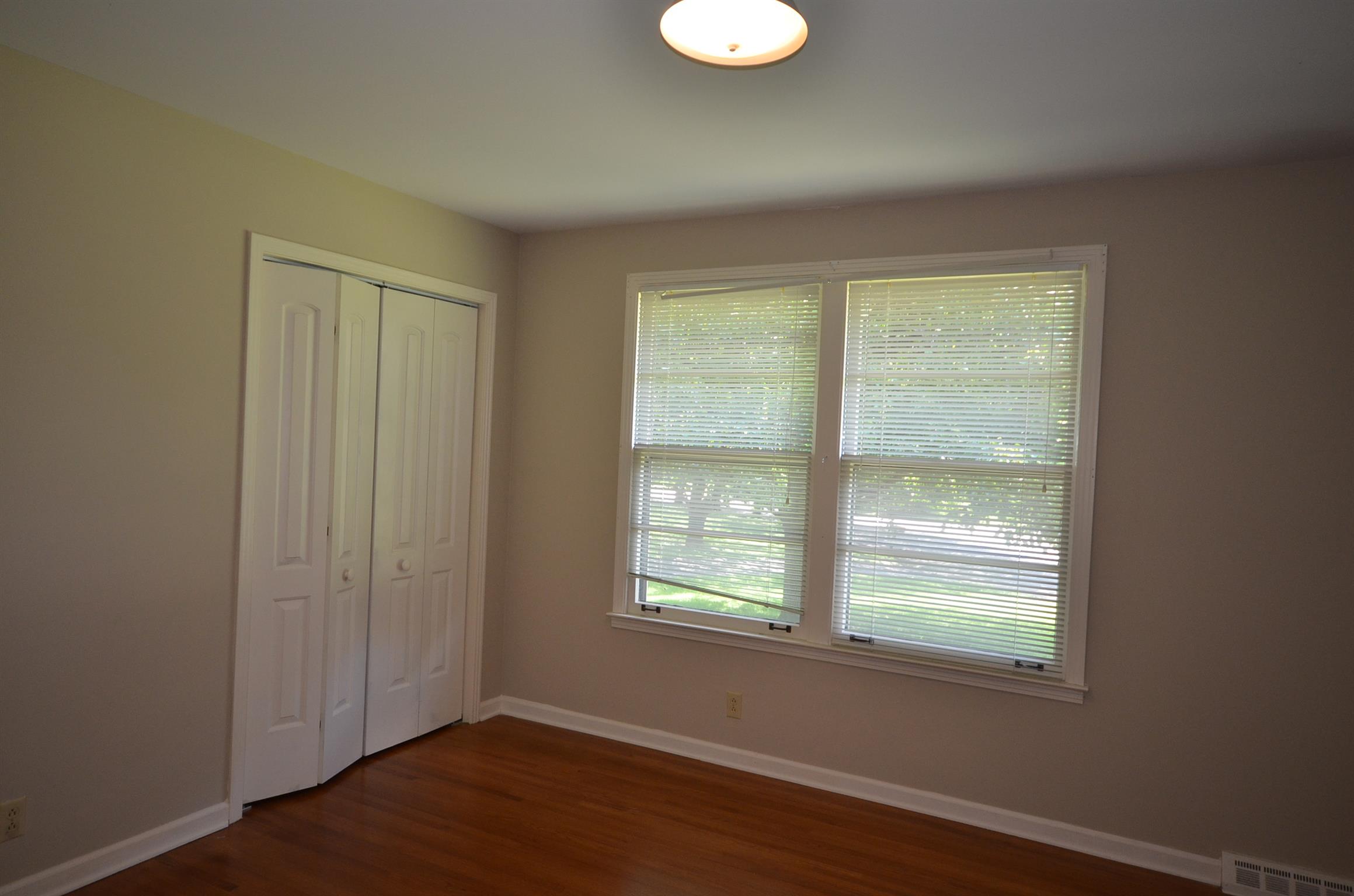 310 Kimbrough Road Clarksville, TN 37043 - Photo 12 of 25 an empty room with wooden floor and windows