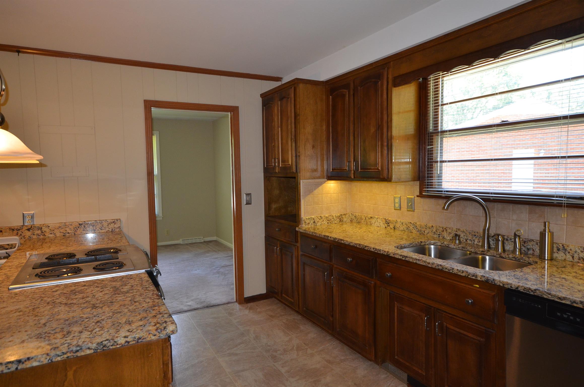 310 Kimbrough Road Clarksville, TN 37043 - Photo 17 of 25 a kitchen with granite countertop wooden cabinets and a stove