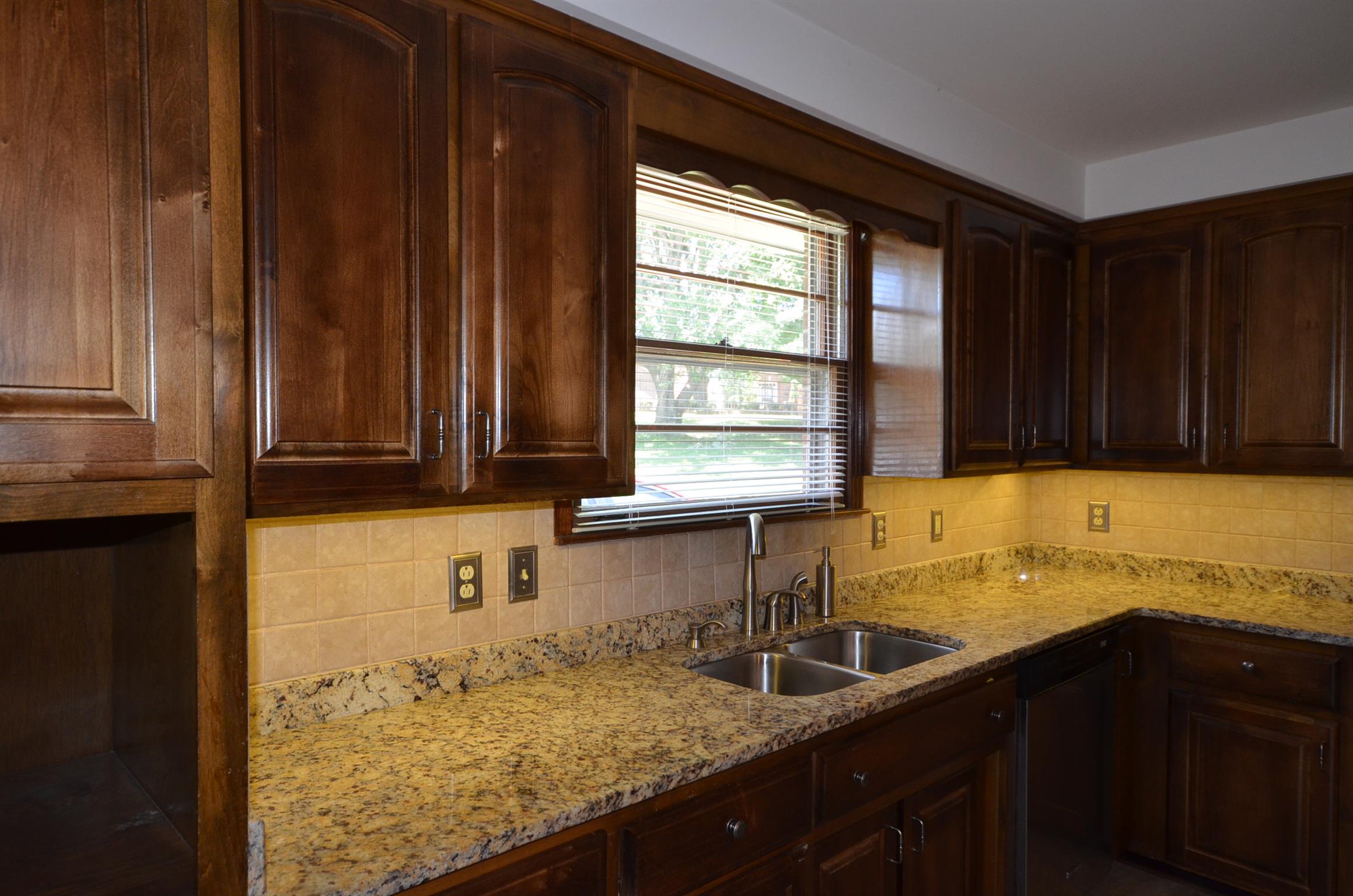 310 Kimbrough Road Clarksville, TN 37043 - Photo 6 of 25 a kitchen with a sink window and cabinets