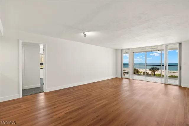 an empty room with large windows