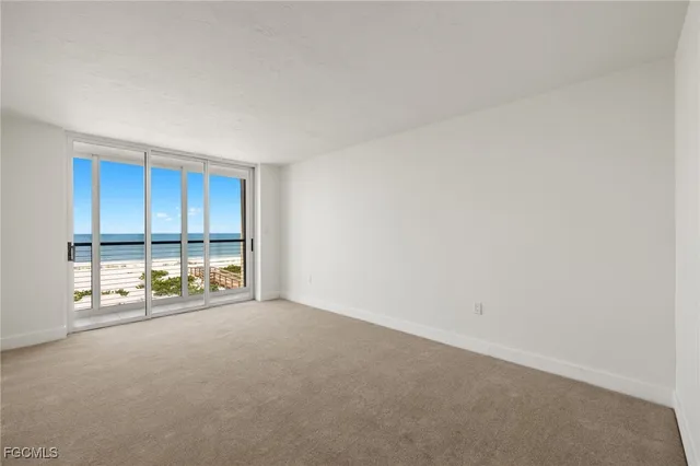 a view of an empty room and a bathroom