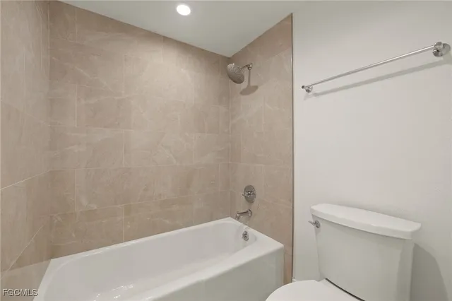 an empty room with a window and a ceiling fan