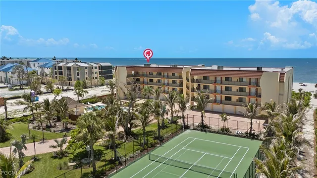 a front view of a building with glass windows and a yard