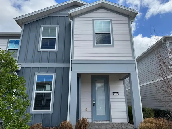 a house that has a tree in front of the house