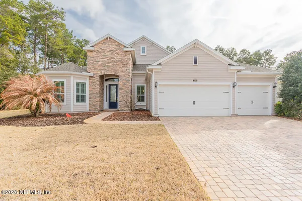 a view of garage yard and front view of a house