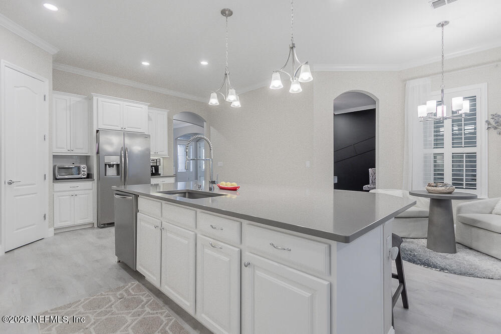 191 Enrede Lane St. Augustine, FL 32095 - Photo 12 of 44 a kitchen with kitchen island granite countertop a sink cabinets and stainless steel appliances