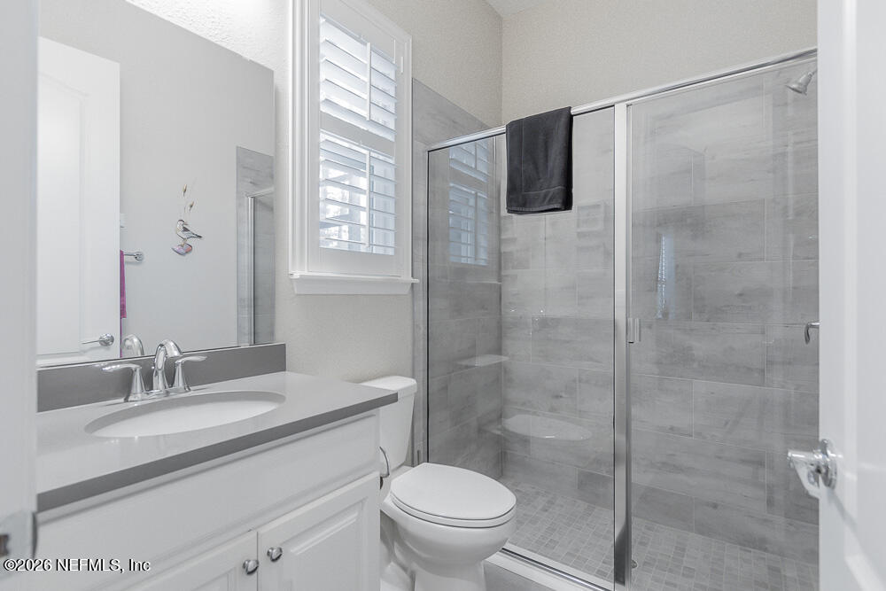 191 Enrede Lane St. Augustine, FL 32095 - Photo 17 of 44 a bathroom with a granite countertop sink toilet and shower