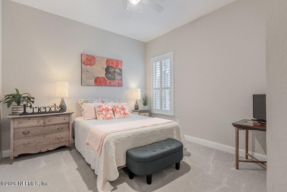 191 Enrede Lane St. Augustine, FL 32095 - Photo 27 of 44 a bedroom with a bed and a lamp on dresser