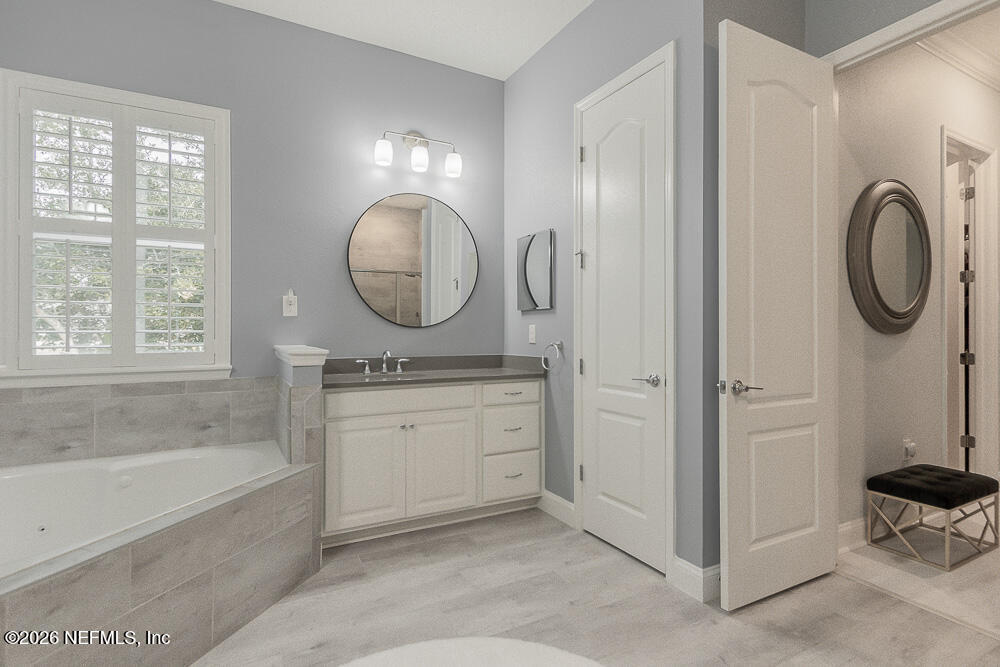 191 Enrede Lane St. Augustine, FL 32095 - Photo 29 of 44 a spacious bathroom with a mirror a bathtub and a sink