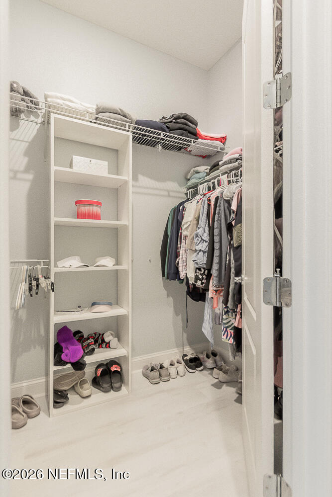 191 Enrede Lane St. Augustine, FL 32095 - Photo 30 of 44 a view of walk in closet with clothes and shoes