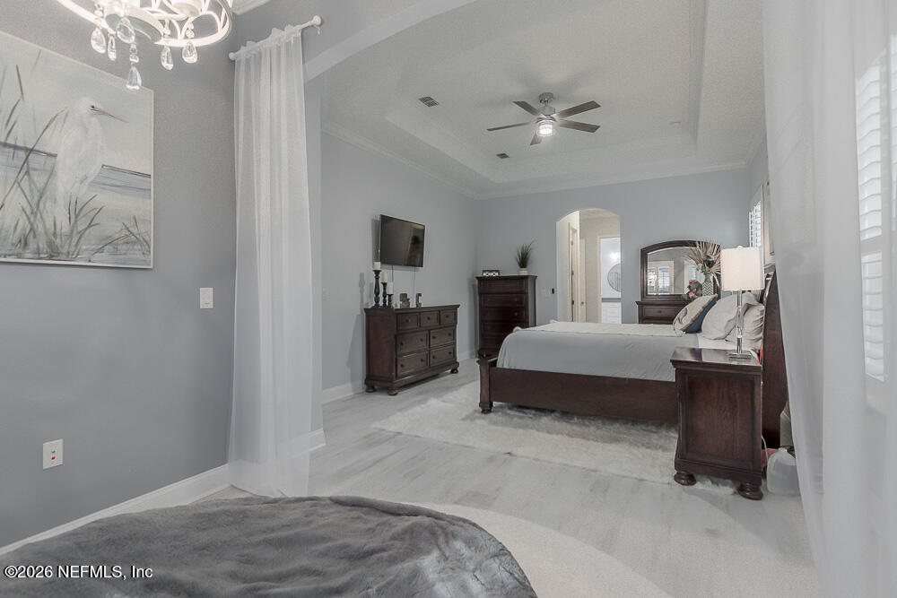 191 Enrede Lane St. Augustine, FL 32095 - Photo 34 of 44 a bedroom with a large bed lamps and table