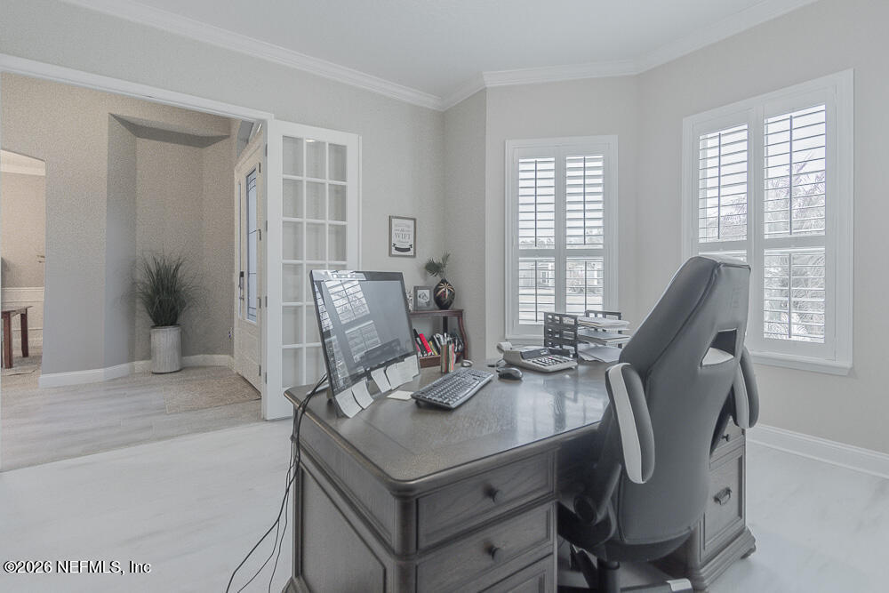 191 Enrede Lane St. Augustine, FL 32095 - Photo 4 of 44 a view of a workspace with furniture and a window