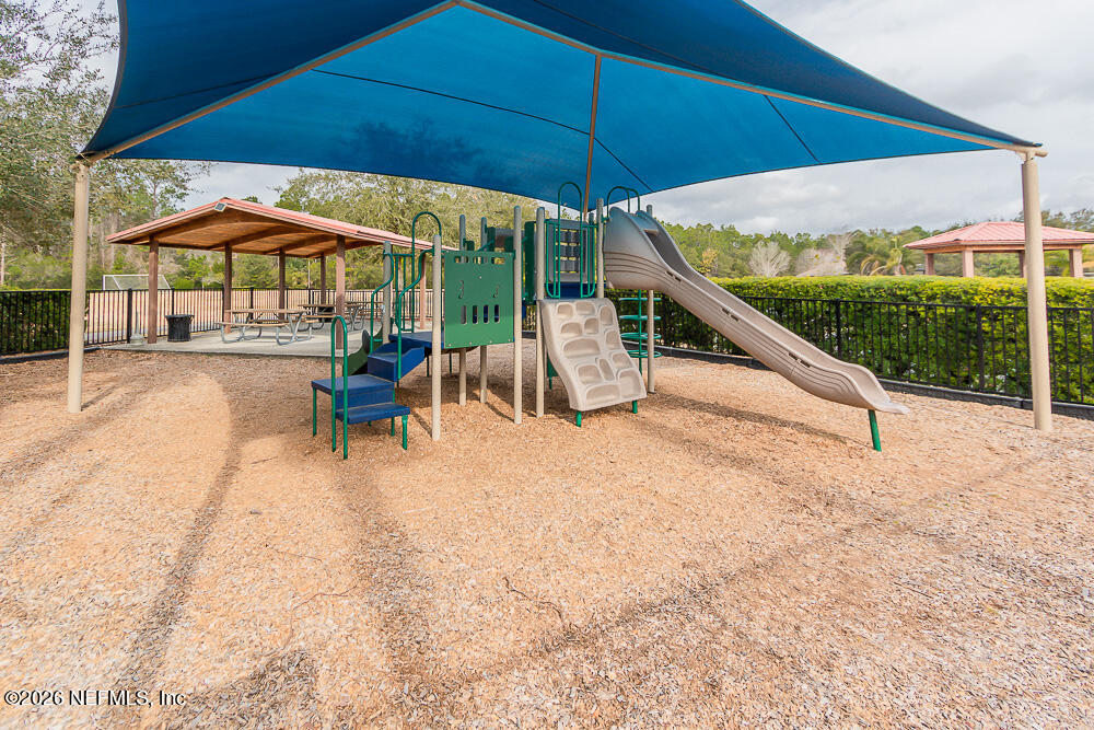 191 Enrede Lane St. Augustine, FL 32095 - Photo 41 of 44 an outdoor space with furniture and umbrella