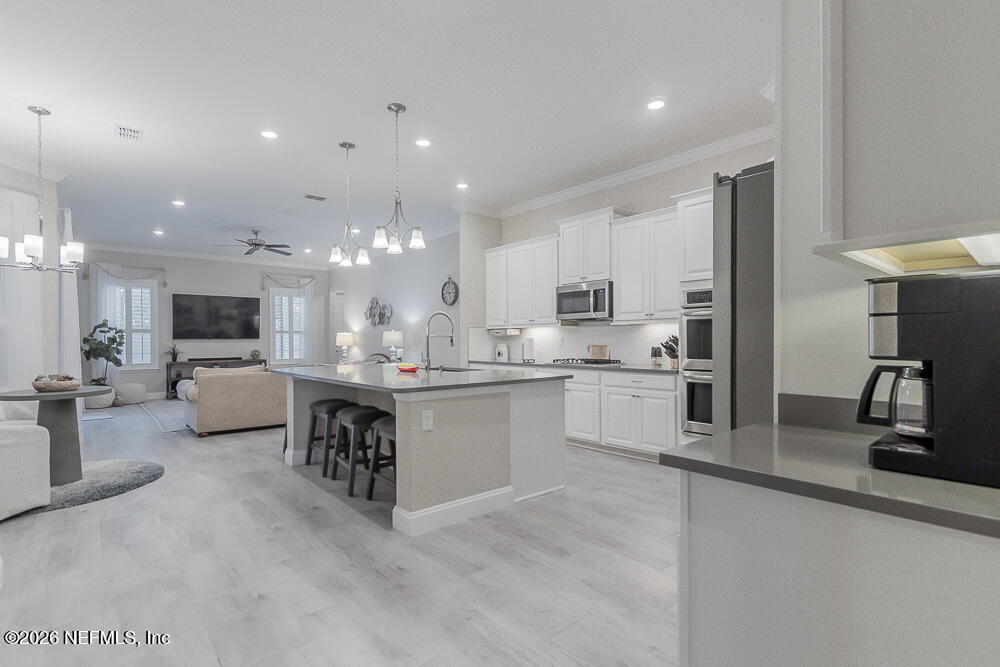 191 Enrede Lane St. Augustine, FL 32095 - Photo 10 of 44 a kitchen with kitchen island a counter top space a sink stainless steel appliances and cabinets