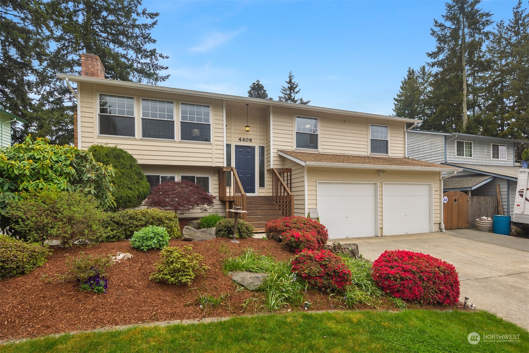 4409 Southeast 4th Street Renton, WA 98059 - Photo 1 of 39 a front view of a house with a yard
