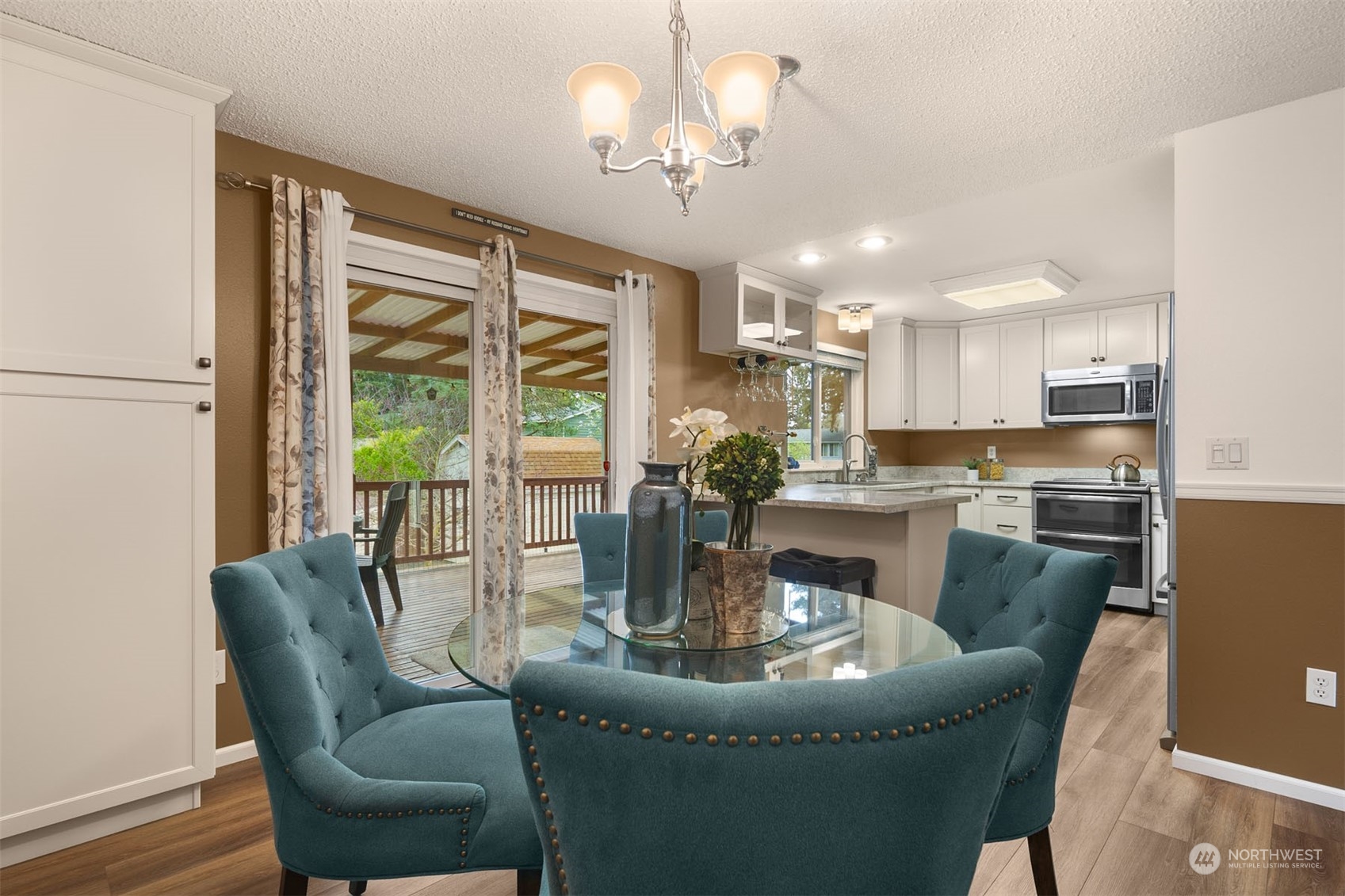 4409 Southeast 4th Street Renton, WA 98059 - Photo 9 of 39 a dining room with furniture a chandelier and wooden floor