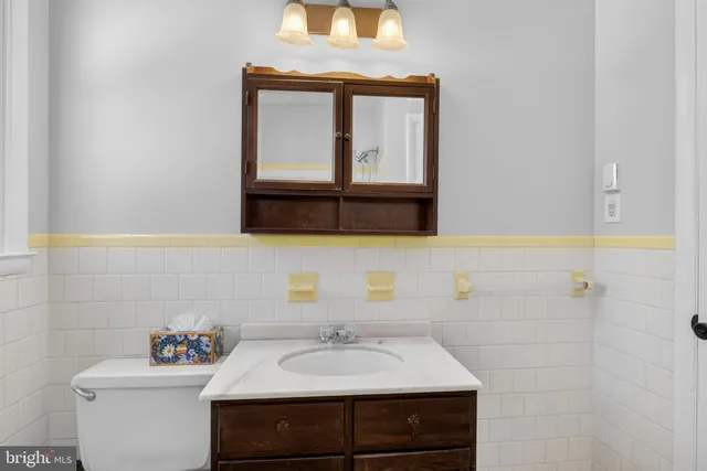 a bathroom with a sink vanity and a mirror
