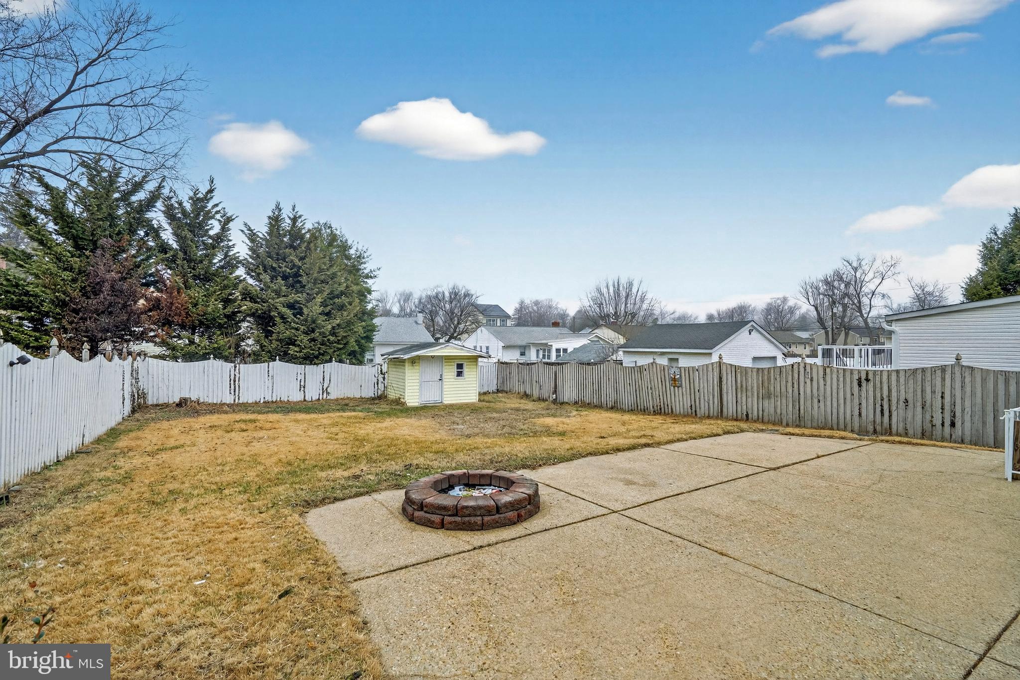 222 Chelsea Road Pasadena, MD 21122 - Photo 44 of 47 Large cement patio with firepit in back yard