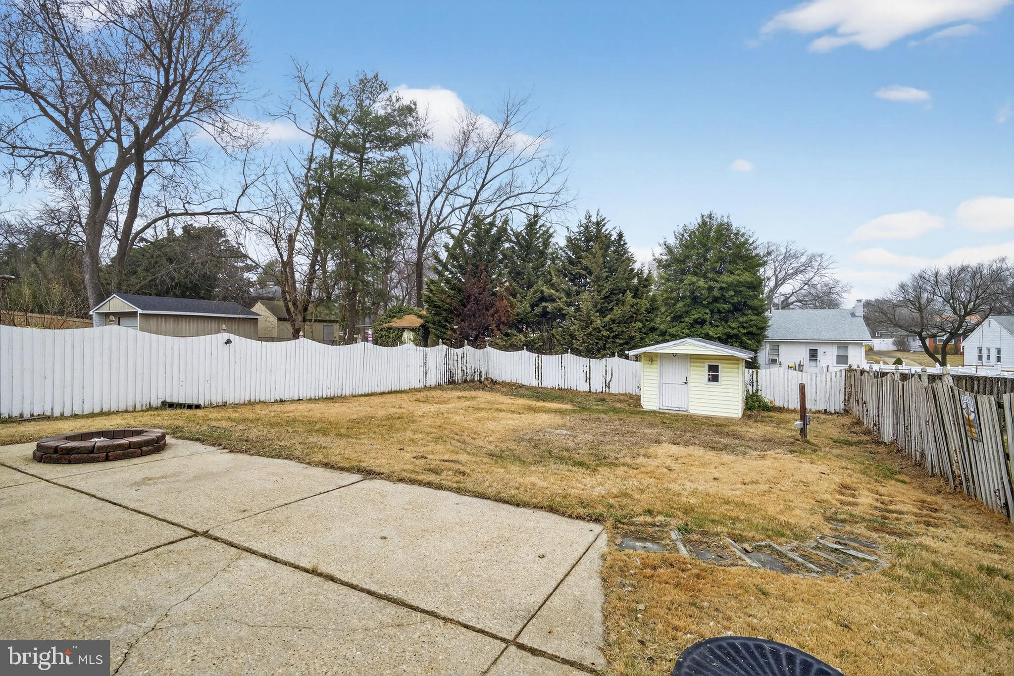 222 Chelsea Road Pasadena, MD 21122 - Photo 45 of 47 Large cement patio with firepit in back yard