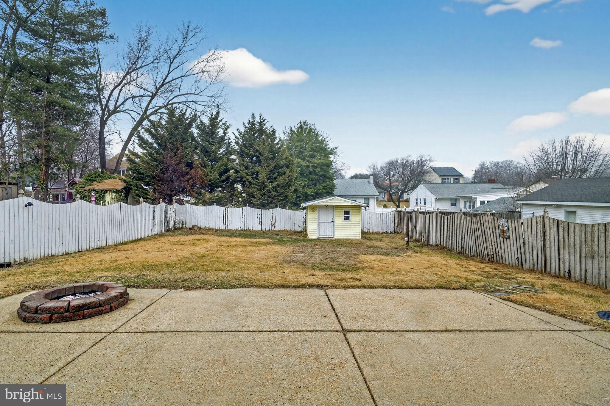 222 Chelsea Road Pasadena, MD 21122 - Photo 46 of 47 Large cement patio with firepit in back yard
