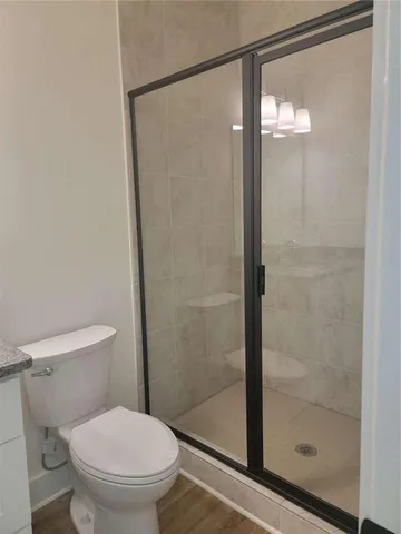 a bathroom with a shower and a toilet