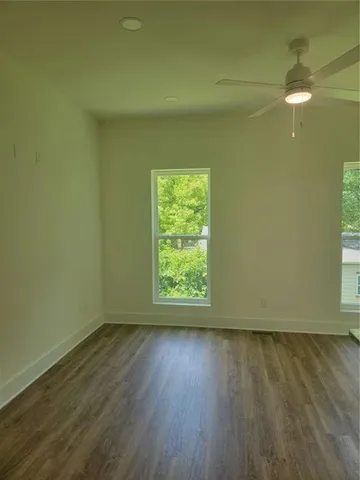 a view of room with window and wooden floor