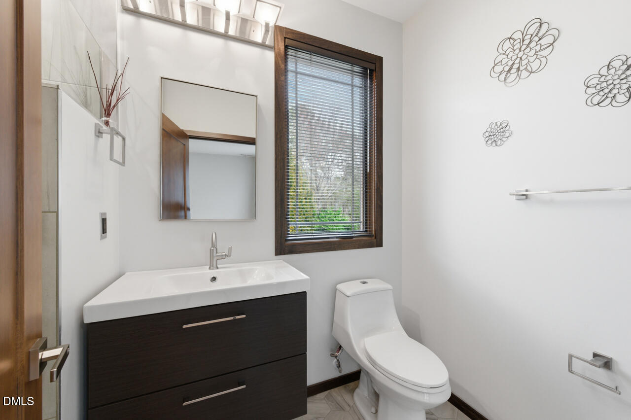 3315 Denada Path Durham, NC 27707 - Photo 38 of 74 a bathroom with a toilet sink and mirror