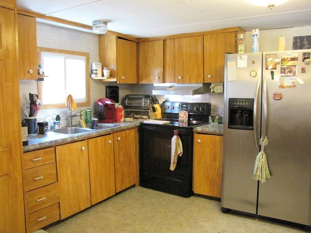 1400 Brimfield Road Warren, MA 01010 - Photo 5 of 17 a kitchen with stainless steel appliances granite countertop a refrigerator a sink a stove with cabinets