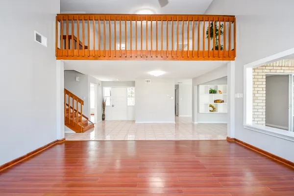 a view of an entryway with wooden floor