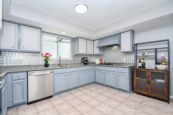 a kitchen with a sink stove top oven and cabinets