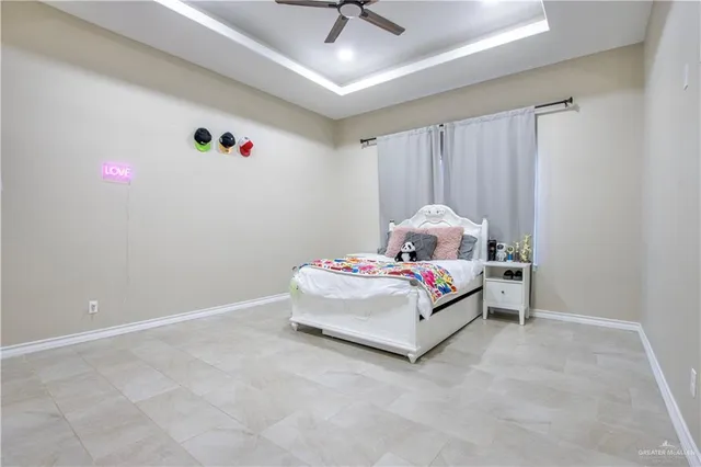 a white bed sitting in a bedroom next to a window