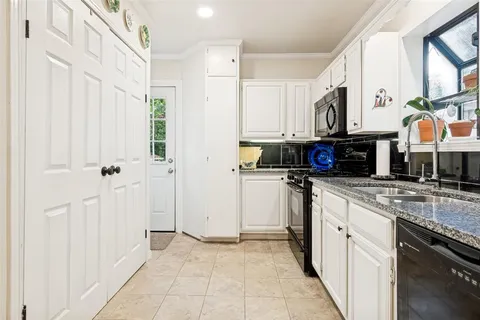 a kitchen with stainless steel appliances granite countertop a refrigerator and a stove