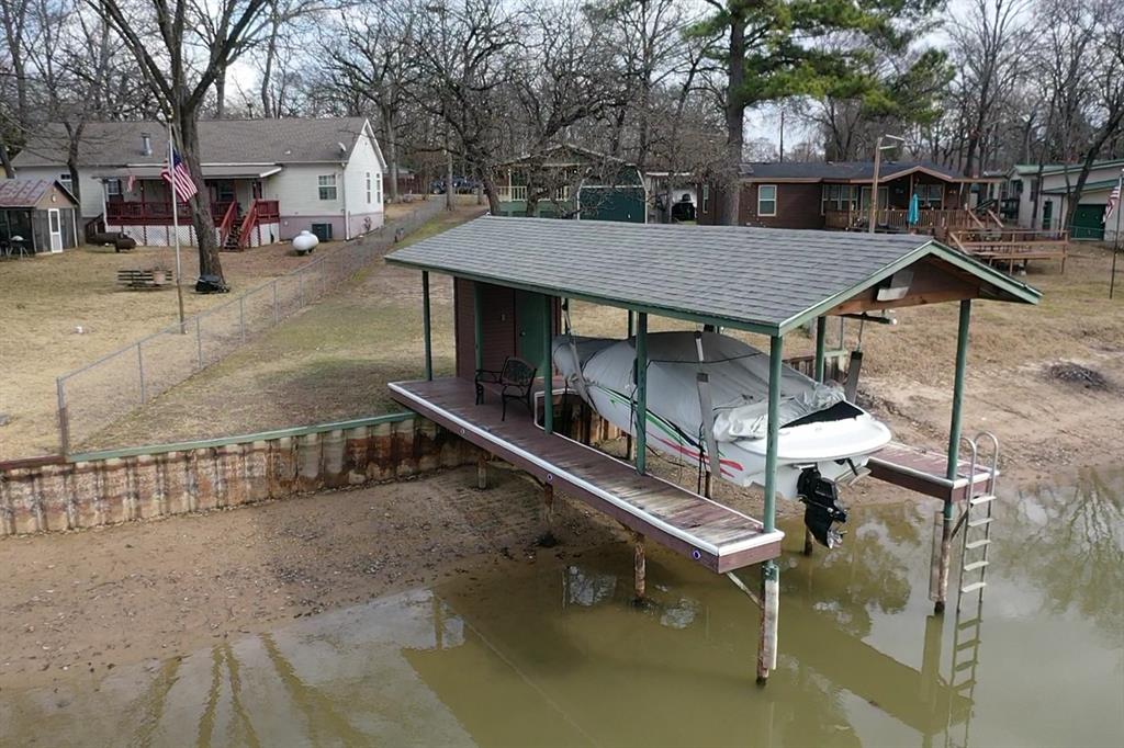 178 Indian Gap Road Mabank, TX 75156 - Photo 22 of 27 Dock with boat lift, a residential view, and a water view
